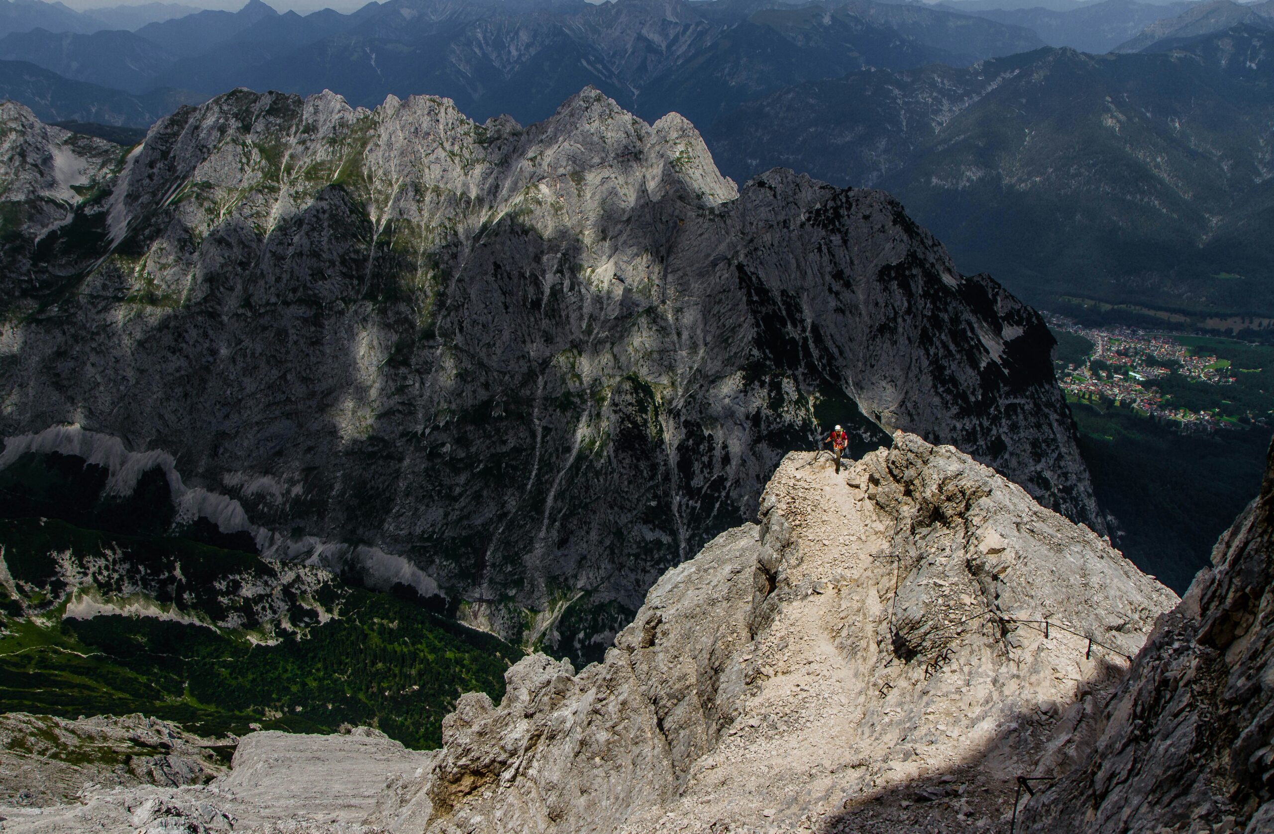 person standing in the peak of mountain range